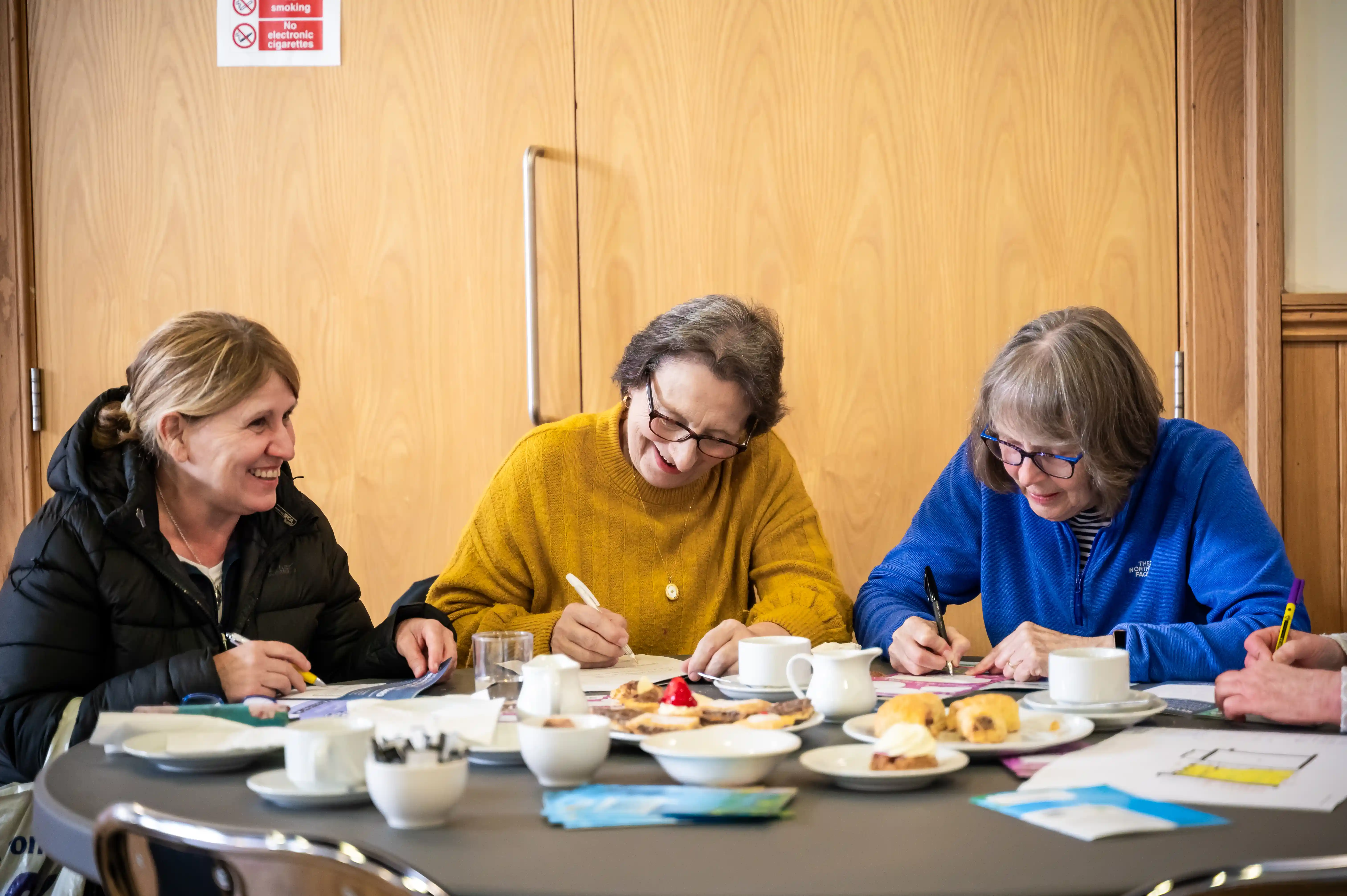 Women filling taking part in a community engagement event at Lanarkshire Climate Action Festival 2024 - Photography by Lucy Knott
