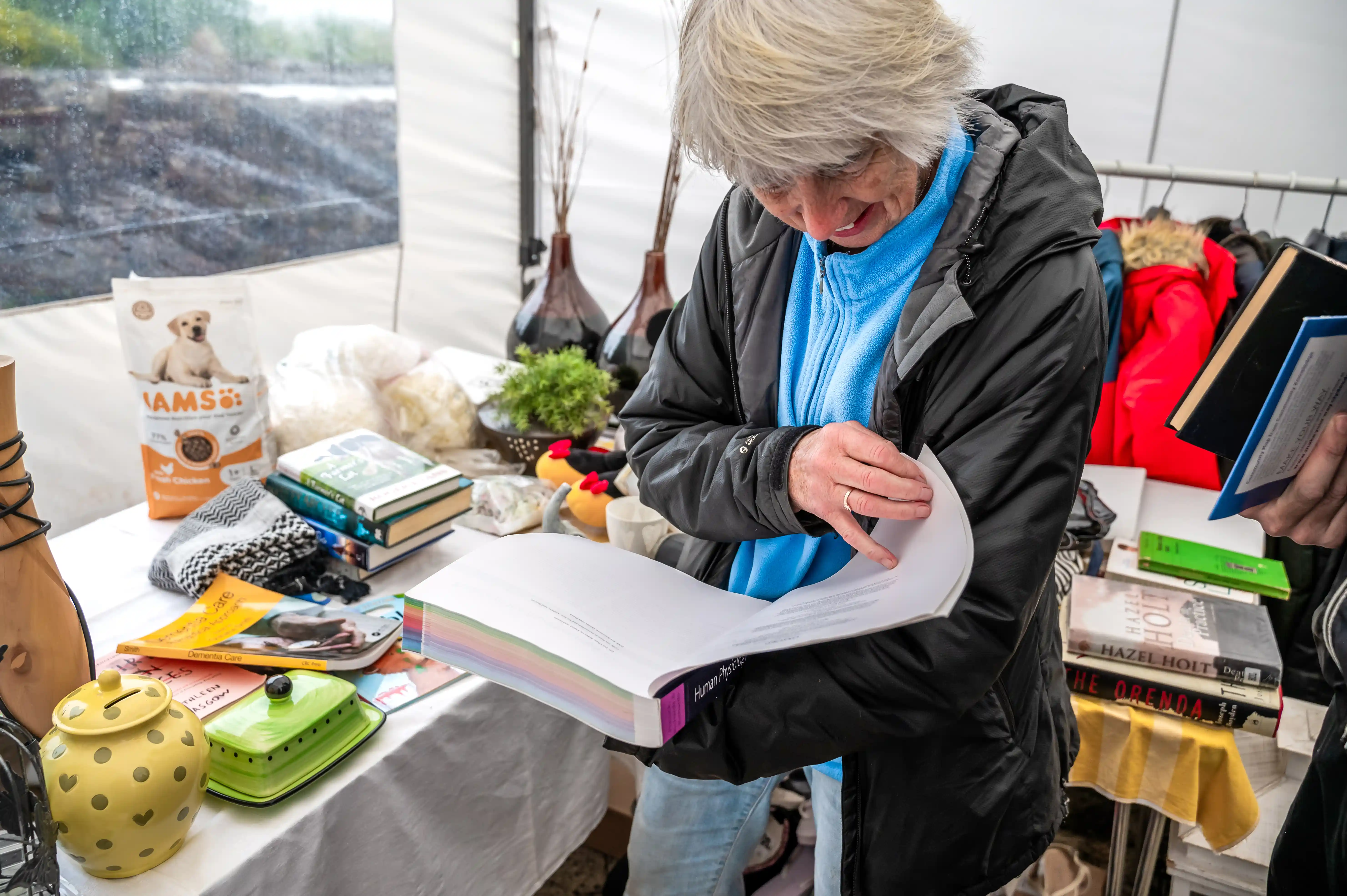 Woman looking through a book at Lanarkshire Climate Action Festival 2024 - Photography by Lucy Knott